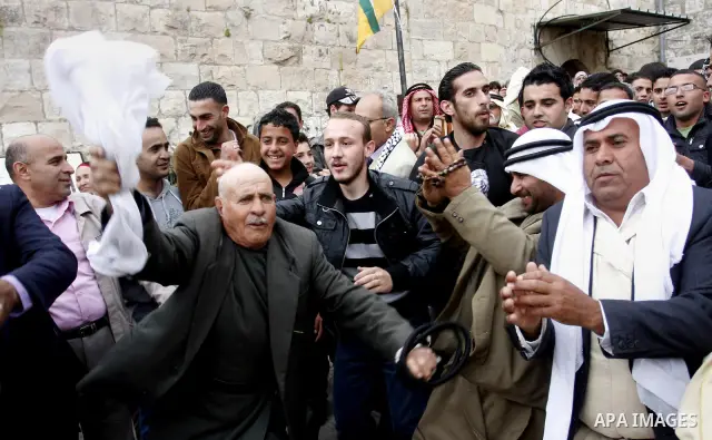 Palestinian celebrates during the wedding of the Palestinian bride and groom Maha Salam (unseen) and Thayer Qasem (unseen) in Deir Istia village the West Bank city of Nablus, on April 12, 2012. The newlyweds traveled fro...