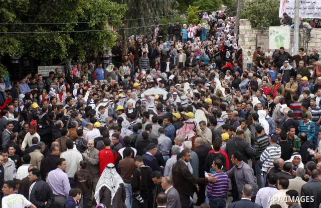 Palestinian celebrates during the wedding of the Palestinian bride and groom Maha Salam (unseen) and Thayer Qasem (unseen) in Deir Istia village the West Bank city of Nablus, on April 12, 2012. The newlyweds traveled fro...