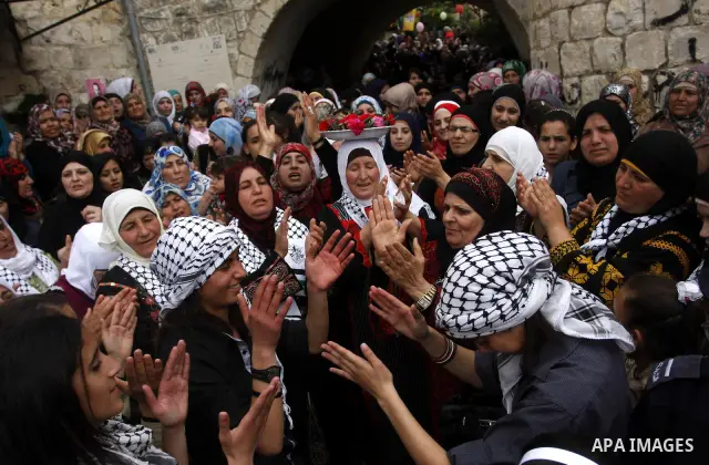 Women celebrates during the wedding of the Palestinian bride and groom Maha Salam (unseen) and Thayer Qasem (unseen) in Deir Istia village the West Bank city of Nablus, on April 12, 2012. The newlyweds traveled from the...