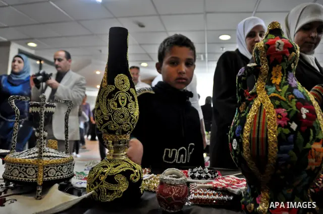 Palestinians participate in an exhibition in the first Palestinian Heritage Jerusalem, in the West Bank city of Nablus, April. 14, 2012. Photo by Nedal Shtieh.