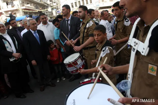 Palestinian Prime Minister Salam Fayyad takes part in the "Holy Fire" procession on the eve of Orthodox Easter in the West Bank city of Ramallah on April 14, 2012. The date of Orthodox Easter is calculated differently th...