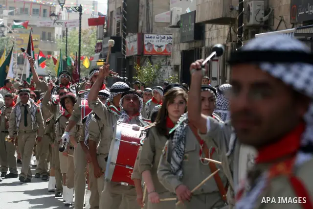 Palestinian Christians take part in the "Holy Fire" procession on the eve of Orthodox Easter in the West Bank city of Ramallah on April 14, 2012. The date of Orthodox Easter is calculated differently than by the Roman Ca...