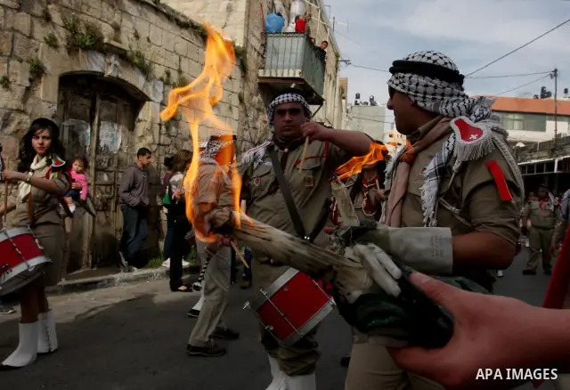 Palestinian Christians take part in the "Holy Fire" procession on the eve of Orthodox Easter in the West Bank city of Ramallah on April 14, 2012. The date of Orthodox Easter is calculated differently than by the Roman Ca...