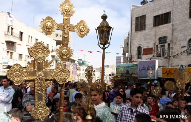 Palestinian Christians take part in the "Holy Fire" procession on the eve of Orthodox Easter in the West Bank city of Ramallah on April 14, 2012. The date of Orthodox Easter is calculated differently than by the Roman Ca...