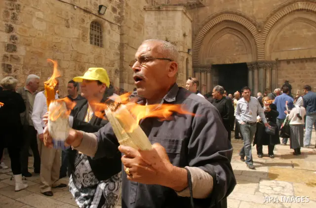 Palestinian Christians from the Greek Orthodox Church chant and sing in the streets with candles and crosses during the Easter Holy Fire ritual in the Old City of Jerusalem on April 14, 2012. during the 'Holy Fire' cerem...