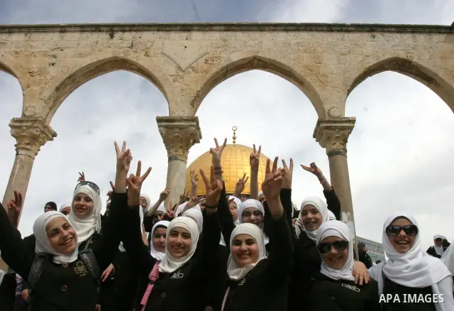 Palestinian girls gathers to play in front of Jerusalem's Dome of the Rock mosque inside the courtyard of the Al-Aqsa mosques compound, Islam's third holiest site, during a ceremony marking the international Children's D...