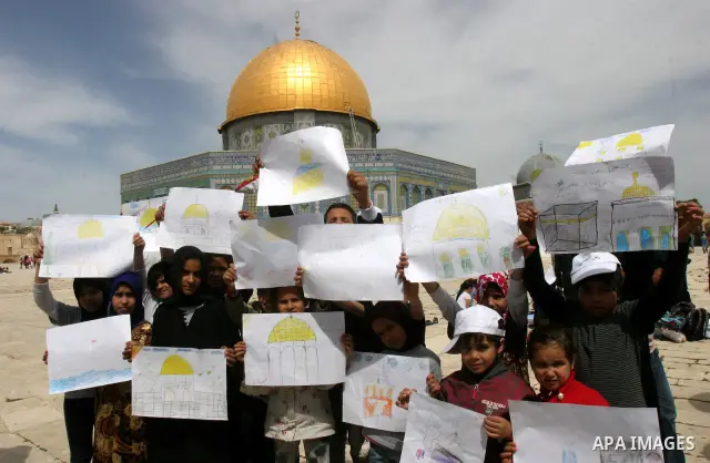 Palestinian girls gathers to play in front of Jerusalem's Dome of the Rock mosque inside the courtyard of the Al-Aqsa mosques compound, Islam's third holiest site, during a ceremony marking the international Children's D...