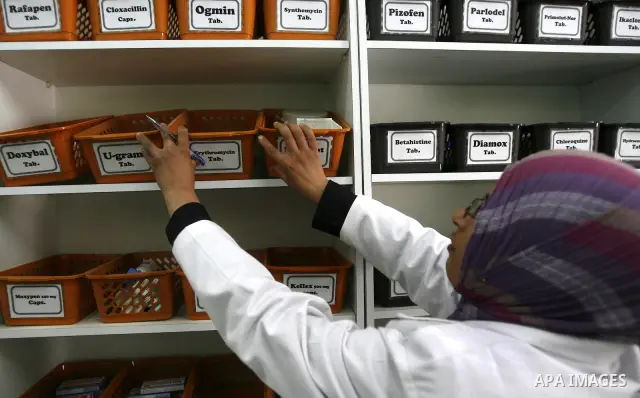 A Palestinian pharmacist stands next shelves which empty from medicines in hospital in Rafah southern Gaza Strip on April, 15, 2012 as Gaza Strip faces a lack of medicines. Photo by Eyad Al Baba