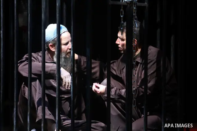 Palestinians perform a play depicting Palestinian prisoners in an Israeli jail in Gaza City on April 16, 2012 on the eve of Prisoners' Day, an annual event during which people hold demonstrations and rallies of solidarit...