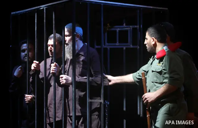 Palestinians perform a play depicting Palestinian prisoners in an Israeli jail in Gaza City on April 16, 2012 on the eve of Prisoners' Day, an annual event during which people hold demonstrations and rallies of solidarit...