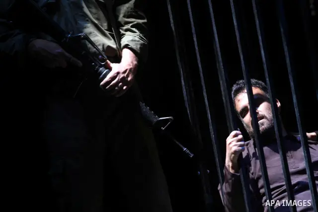 Palestinians perform a play depicting Palestinian prisoners in an Israeli jail in Gaza City on April 16, 2012 on the eve of Prisoners' Day, an annual event during which people hold demonstrations and rallies of solidarit...