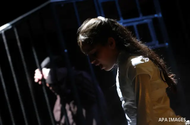 Palestinians perform a play depicting Palestinian prisoners in an Israeli jail in Gaza City on April 16, 2012 on the eve of Prisoners' Day, an annual event during which people hold demonstrations and rallies of solidarit...