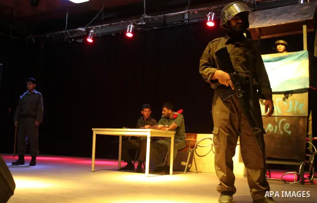 Palestinians perform a play depicting Palestinian prisoners in an Israeli jail in Gaza City on April 16, 2012 on the eve of Prisoners' Day, an annual event during which people hold demonstrations and rallies of solidarit...