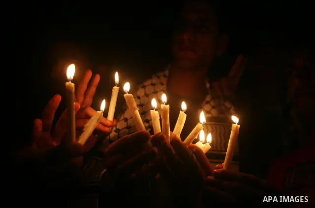 Palestinian man holds candles during a rally in solidarity with Palestinian prisoners held in Israeli jails, in Gaza City, April 16, 2012. Photo by Ali Jadallah