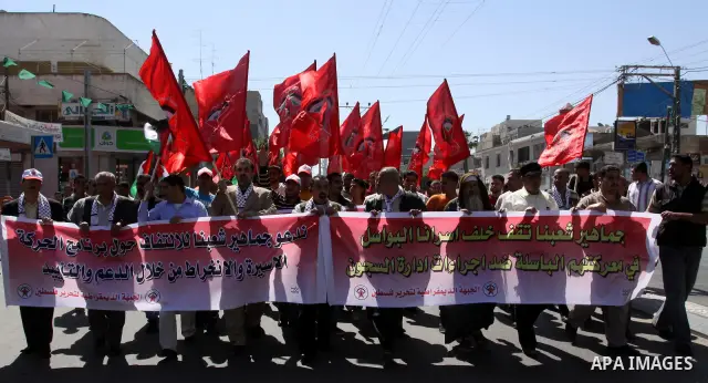 Palestinian protesters wave national flags during a rally in Gaza City on April 17, 2012 in solidarity with Palestinian prisoners held in Israel. Some 1,200 Palestinian prisoners held in Israeli jails have begun a hunger...
