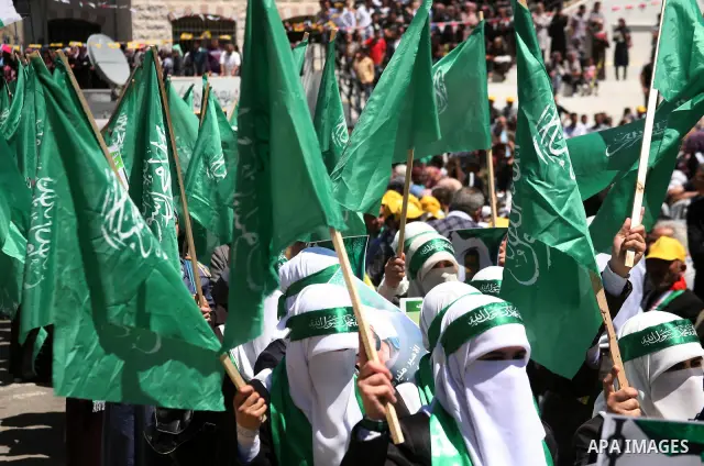Palestinian protesters wave national flags during a rally in West Bank city of Hebron on April 17, 2012 in solidarity with Palestinian prisoners held in Israel. Some 1,200 Palestinian prisoners held in Israeli jails have...