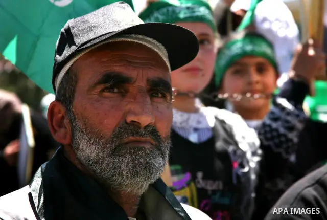 Palestinian protesters wave national flags during a rally in West Bank city of Hebron on April 17, 2012 in solidarity with Palestinian prisoners held in Israel. Some 1,200 Palestinian prisoners held in Israeli jails have...