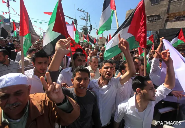 Palestinians demonstrate in solidarity with prisoners jailed in Israel on the annual prisoners day, in Gaza City, Tuesday, April 17, 2012. The Israeli prison service said Tuesday hundreds of Palestinian prisoners have la...