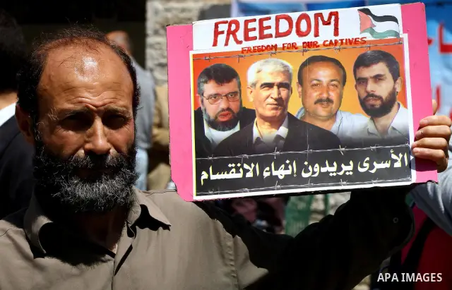 Palestinians demonstrate in solidarity with prisoners jailed in Israel on the annual prisoners day, in Gaza City, Tuesday, April 17, 2012. The Israeli prison service said Tuesday hundreds of Palestinian prisoners have la...