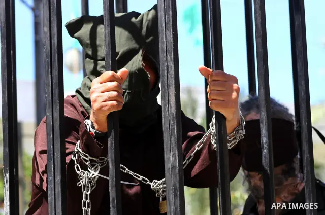 Palestinian boys with handcuffs attend a rally to commemorate the Palestinian Prisoner Day in Gaza City, on April 17, 2012. The Israeli Prisons Authority said on Tuesday in a written statement that 2,300 Palestinian pris...