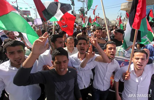 Palestinians demonstrate in solidarity with prisoners jailed in Israel on the annual prisoners day, in Gaza City, Tuesday, April 17, 2012. The Israeli prison service said Tuesday hundreds of Palestinian prisoners have la...