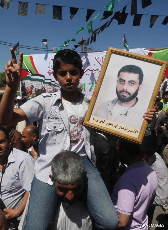 Palestinians demonstrate in solidarity with prisoners jailed in Israel on the annual prisoners day, in Gaza City, Tuesday, April 17, 2012. The Israeli prison service said Tuesday hundreds of Palestinian prisoners have la...