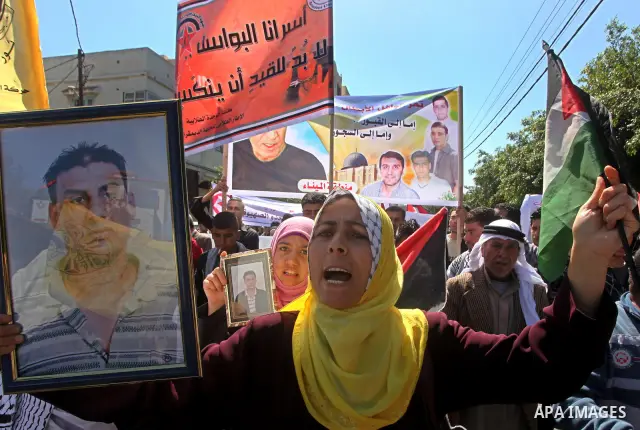 Palestinians demonstrate in solidarity with prisoners jailed in Israel on the annual prisoners day, in Gaza City, Tuesday, April 17, 2012. The Israeli prison service said Tuesday hundreds of Palestinian prisoners have la...