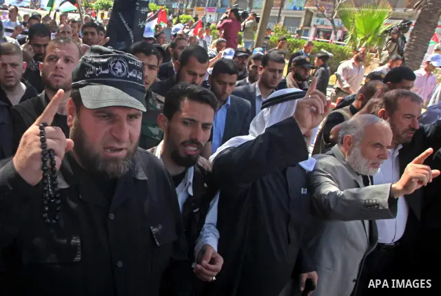 Palestinian factions demonstrate in solidarity with prisoners jailed in Israel on the annual prisoners day, in Gaza City, Tuesday, April 17, 2012. The Israeli prison service said Tuesday hundreds of Palestinian prisoners...