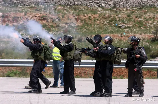 Israeli soldiers fire teargas during clashes with Palestinian protesters following a demonstration to mark the Prisoners' Day near Israels Ofer prison, between Jerusalem and Ramallah on April 17, 2012. At least 1,200 Pa...