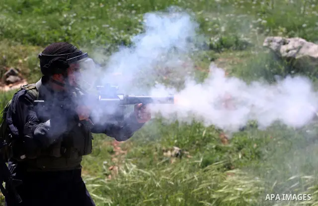 Israeli soldiers fire teargas during clashes with Palestinian protesters following a demonstration to mark the Prisoners' Day near Israels Ofer prison, between Jerusalem and Ramallah on April 17, 2012. At least 1,200 Pa...