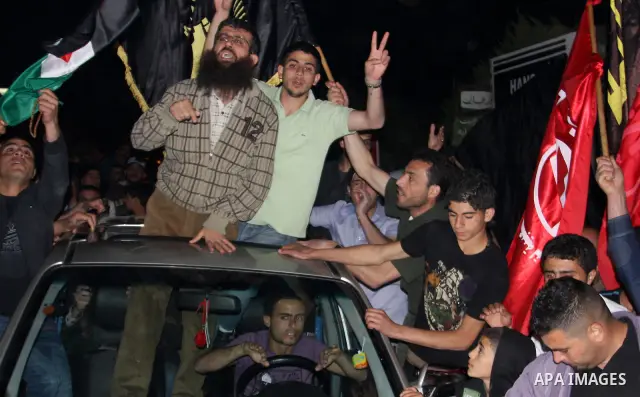 Khader Adnan, a member of Islamic Jihad, gestures upon his arrival in the West Bank village of Arabe near Jenin after his release from an Israeli prison, April 17, 2012. Adnan, a prisoner who refused food for 66 days bef...