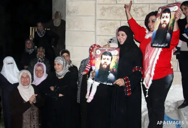 Khader Adnan, a member of Islamic Jihad, gestures upon his arrival in the West Bank village of Arabe near Jenin after his release from an Israeli prison, April 17, 2012. Adnan, a prisoner who refused food for 66 days bef...