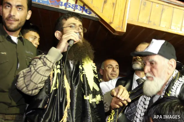 Khader Adnan, a member of Islamic Jihad, gestures upon his arrival in the West Bank village of Arabe near Jenin after his release from an Israeli prison, April 17, 2012. Adnan, a prisoner who refused food for 66 days bef...