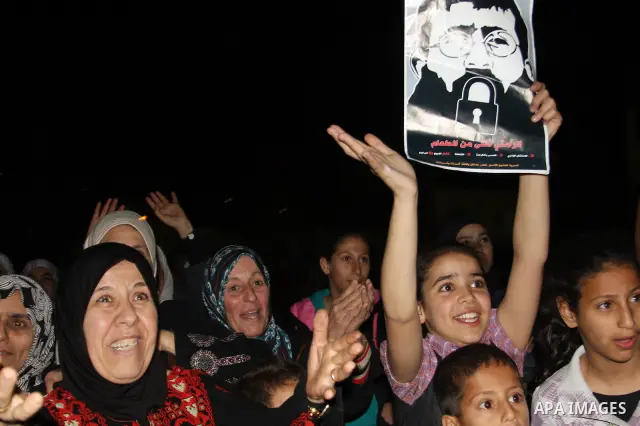Khader Adnan, a member of Islamic Jihad, gestures upon his arrival in the West Bank village of Arabe near Jenin after his release from an Israeli prison, April 17, 2012. Adnan, a prisoner who refused food for 66 days bef...