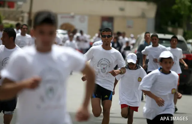 Palestinian athletes ran in the Olympic Marathon (100 days before the start of the London Olympics 2012) in the West Bank city of Ramallah April 18, 2012. Photo by Issam Rimawi