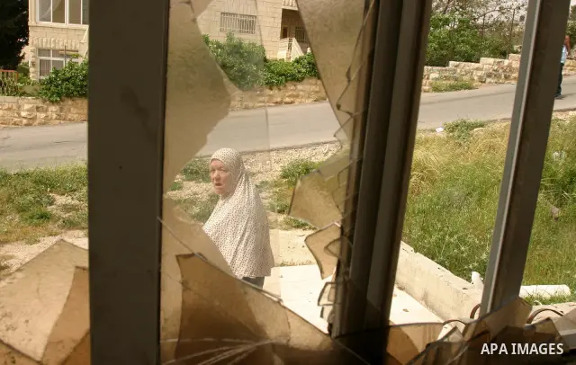 A Palestinian woman of the Khaled Natsheh household look on as their furniture is removed following their forced eviction by Israeli authorities, handing over their home to Jewish settlers in the Israeli annexed east Jer...