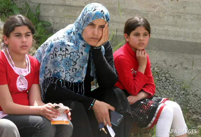 Female Palestinian members of the Khaled Natsheh household look on as their furniture is removed following their forced eviction by Israeli authorities, handing over their home to Jewish settlers in the Israeli annexed e...