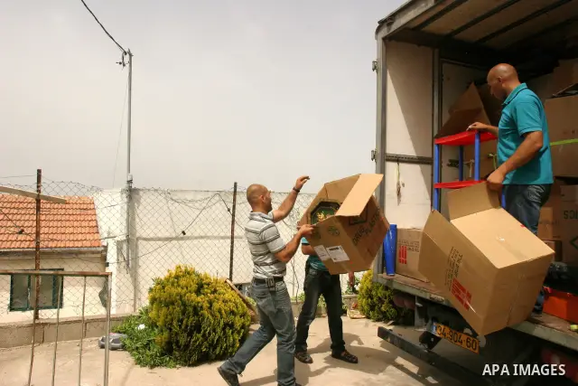 Palestinian members of the Khaled Natsheh household transfer on as their furniture is removed following their forced eviction by Israeli authorities, handing over their home to Jewish settlers in the Israeli annexed east...