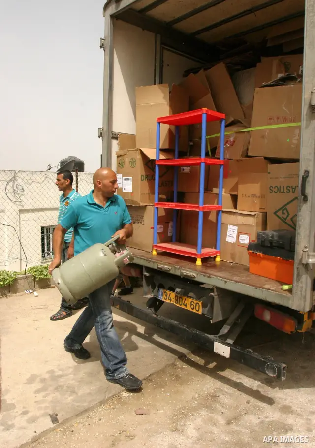 Palestinian members of the Khaled Natsheh household transfer on as their furniture is removed following their forced eviction by Israeli authorities, handing over their home to Jewish settlers in the Israeli annexed east...