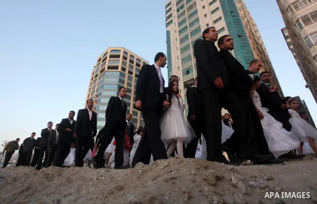 Palestinians celebrate during a mass wedding organized by Association of Altayseer for marriage. Around 60 young Palestinians Participated in the wedding in Gaza City on April 19, 2012. Photo by Ashraf Amra