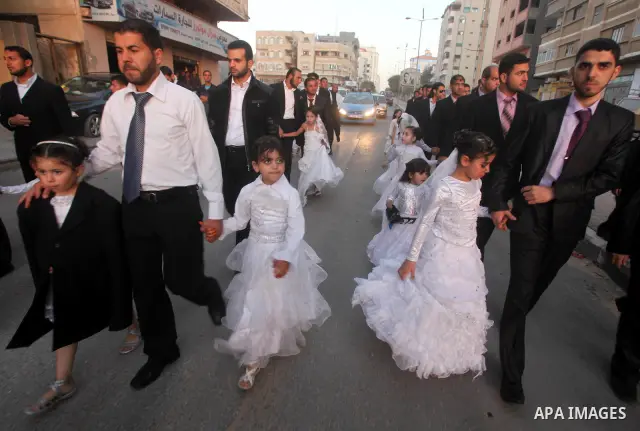 Palestinians celebrate during a mass wedding organized by Association of Altayseer for marriage. Around 60 young Palestinians Participated in the wedding in Gaza City on April 19, 2012. Photo by Ashraf Amra