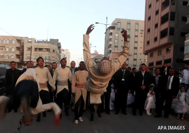 Palestinians celebrate during a mass wedding organized by Association of Altayseer for marriage. Around 60 young Palestinians Participated in the wedding in Gaza City on April 19, 2012. Photo by Ashraf Amra