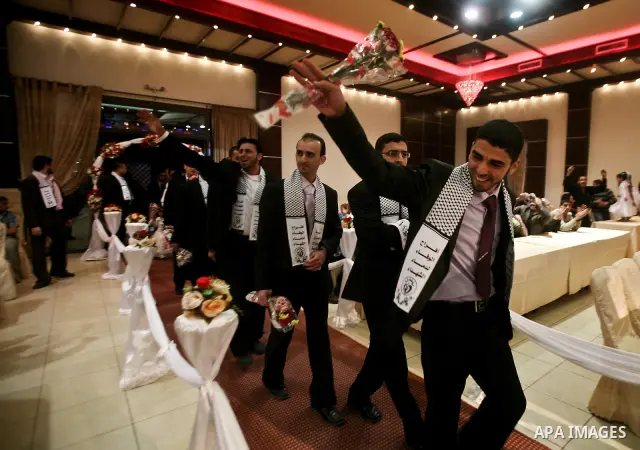 Palestinians celebrate during a mass wedding organized by Association of Altayseer for marriage. Around 60 young Palestinians Participated in the wedding in Gaza City on April 19, 2012. Photo by Ali Jadallah