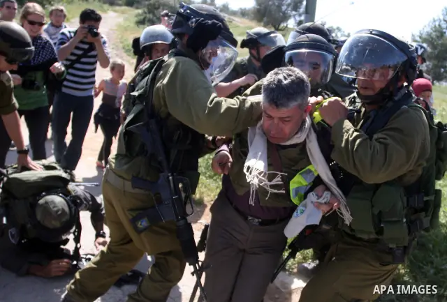 Palestinian and foreign activists confront Israeli soldiers during clashes in the weekly Friday demonstration in the West Bank village of Nabi Saleh, on April 20, 2012, against the construction of the nearby Jewish settl...