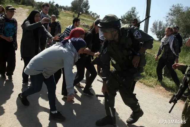 Palestinian and foreign activists confront Israeli soldiers during clashes in the weekly Friday demonstration in the West Bank village of Nabi Saleh, on April 20, 2012, against the construction of the nearby Jewish settl...