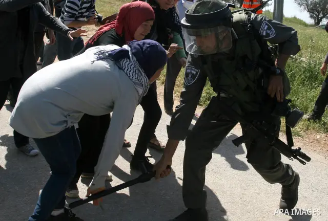Palestinian and foreign activists confront Israeli soldiers during clashes in the weekly Friday demonstration in the West Bank village of Nabi Saleh, on April 20, 2012, against the construction of the nearby Jewish settl...