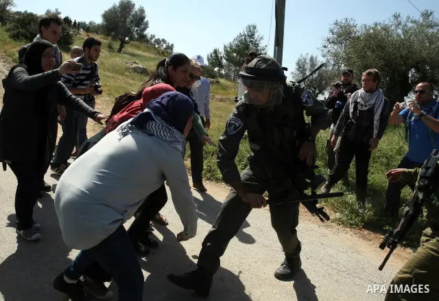 Palestinian and foreign activists confront Israeli soldiers during clashes in the weekly Friday demonstration in the West Bank village of Nabi Saleh, on April 20, 2012, against the construction of the nearby Jewish settl...