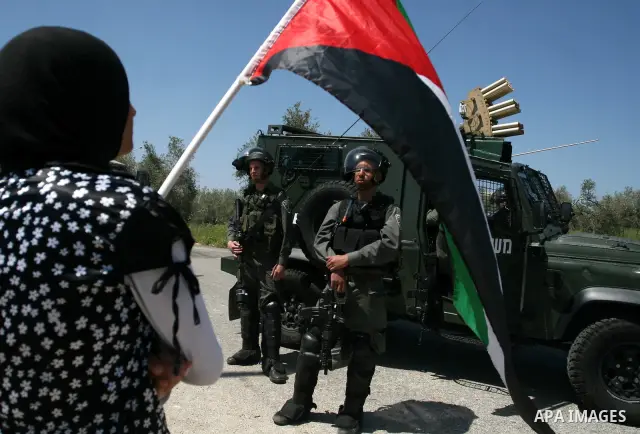 Palestinian and foreign activists confront Israeli soldiers during clashes in the weekly Friday demonstration in the West Bank village of Nabi Saleh, on April 20, 2012, against the construction of the nearby Jewish settl...