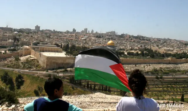 Palestinian demonstrate on the Mount of Olives, which overlooks the Dome of the Rock in the Al-Aqsa mosque compound, as they protest against the Jewish settlers who live in the Israeli annexed Arab East Jerusalem's a-Tur...