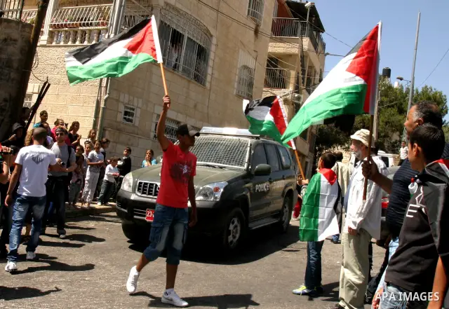 Palestinian demonstrate on the Mount of Olives, which overlooks the Dome of the Rock in the Al-Aqsa mosque compound, as they protest against the Jewish settlers who live in the Israeli annexed Arab East Jerusalem's a-Tur...